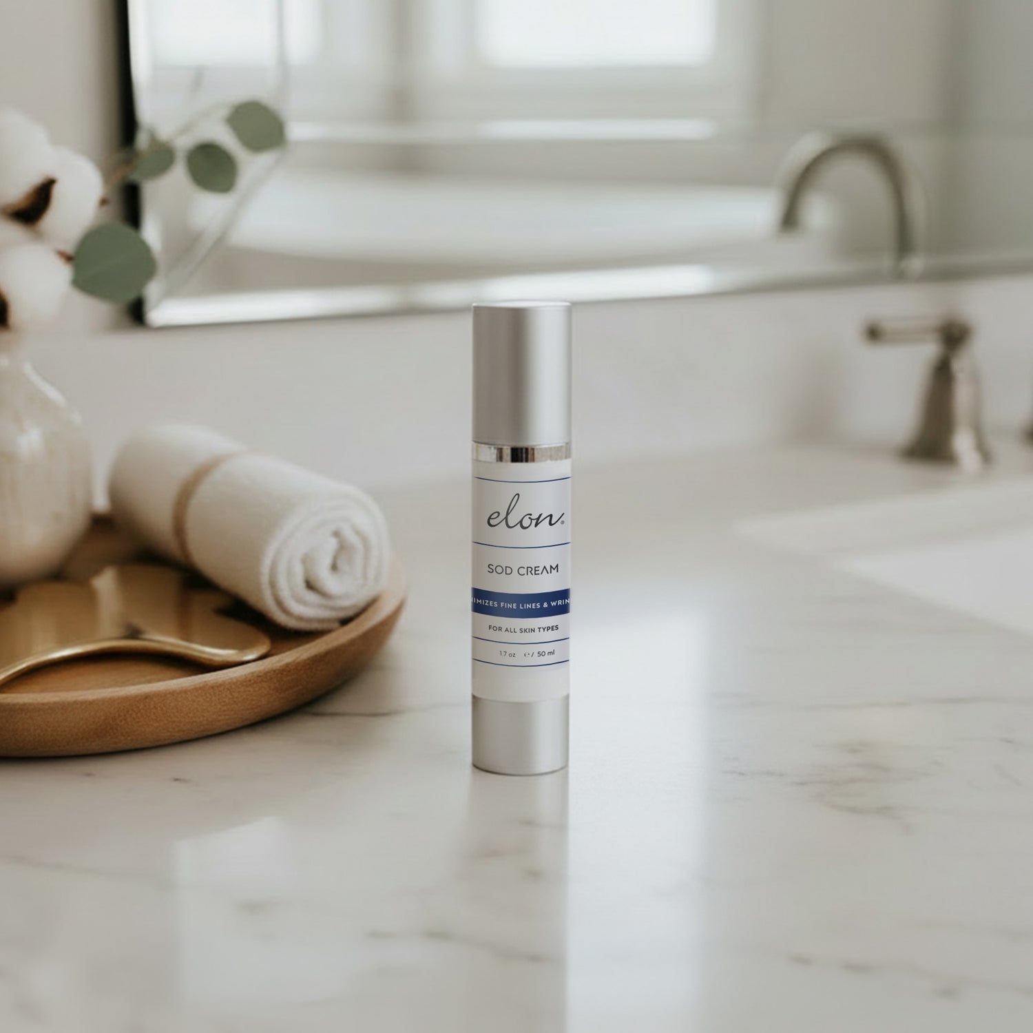 Elon SOD cream on a marble countertop with a blurred bathroom background