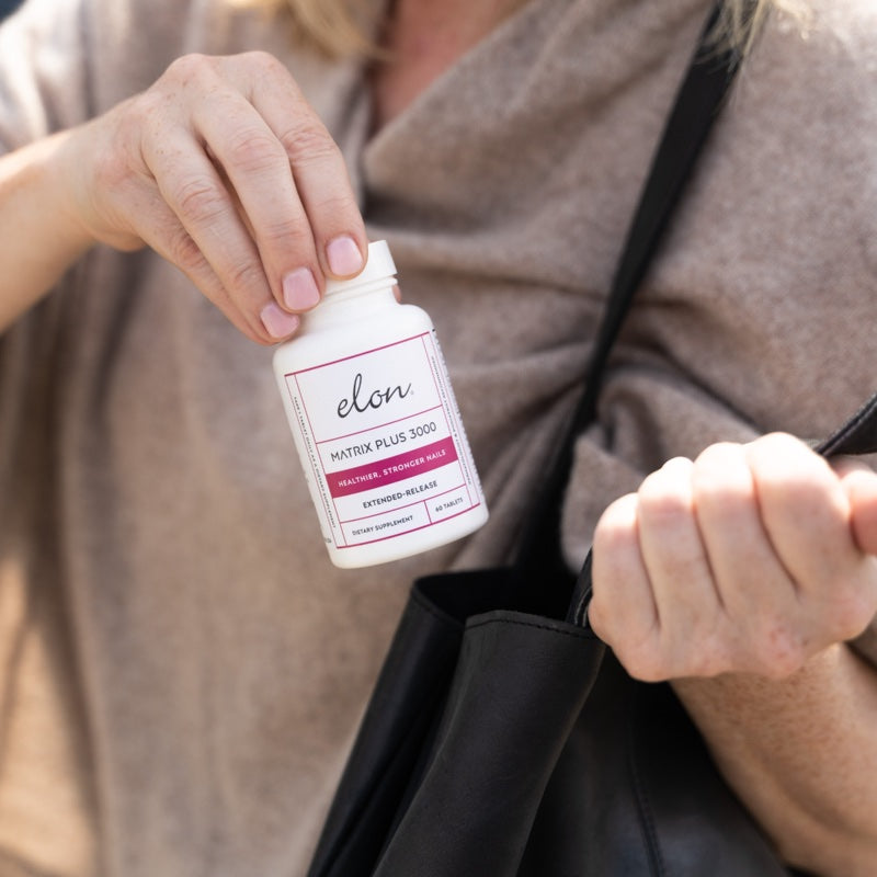 Woman holding Elon Matrix Plus 3000